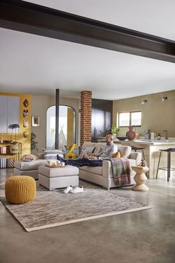 Ben Anderson on the Spinn left hand facing chaise sofa in Latte