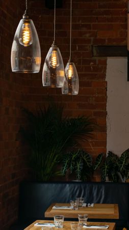 Three XL Skinny Ribbed Upton pendant lights in a restaurant